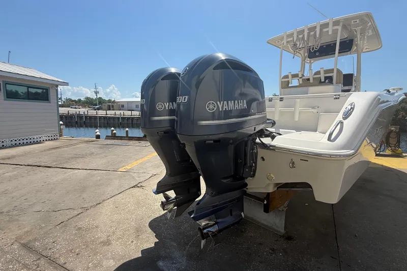 Slide: The Image of 2019 Key West Billistic 281 Center Console with twin Yamaha outboard motors at dock. - 10