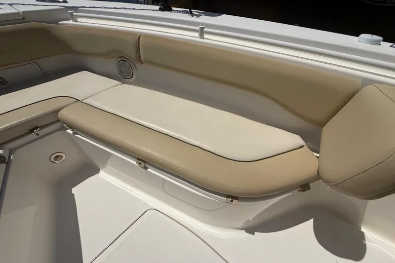 Slide: The Image of 2019 Key West Billistic 281 Center Console boat seating area with beige cushions. - 102