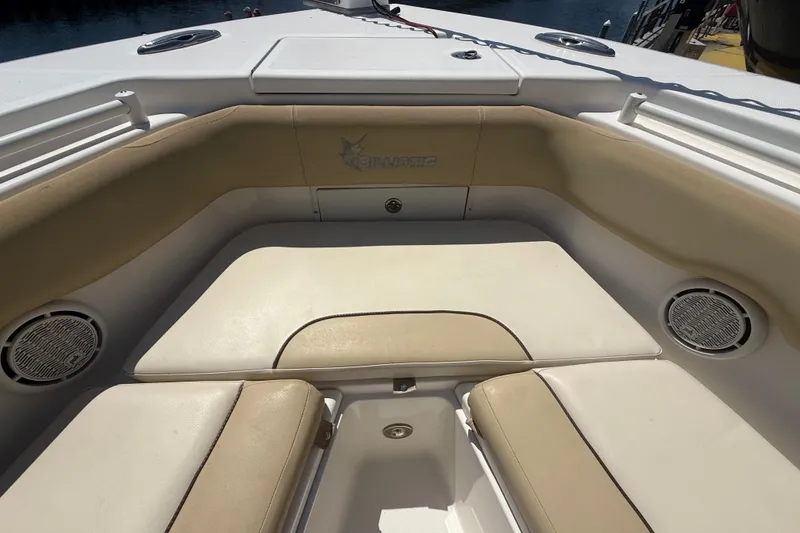 Slide: The Image of 2019 Key West Billistic 281 Center Console boat interior with beige seating and speakers. - 103