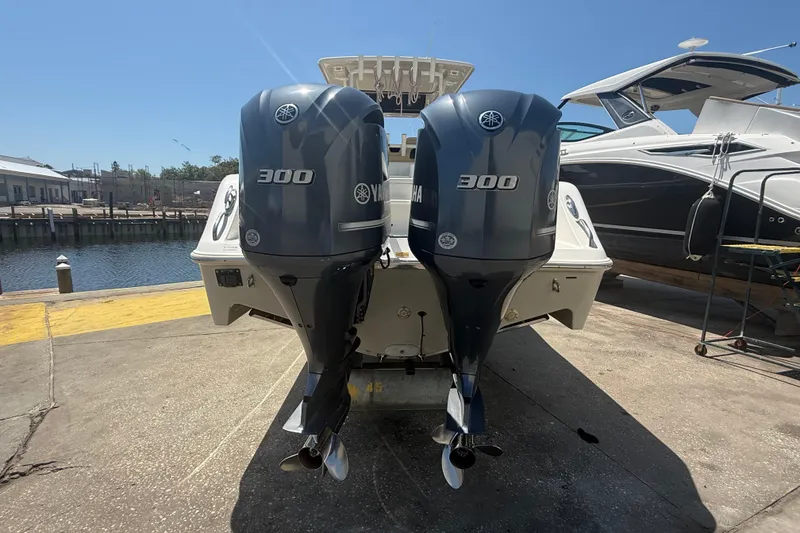 Slide: The Image of 2019 Key West Billistic 281 Center Console with twin Yamaha 300 engines at dock. - 11