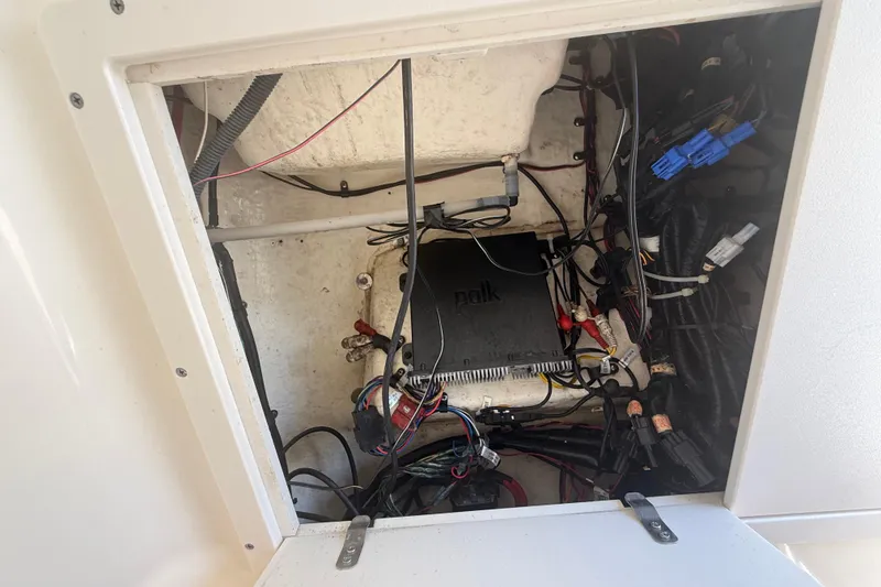 Slide: The Image of 2019 Key West Billistic 281 Center Console electrical compartment with Polk audio system. - 110