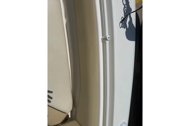 Slide: The Image of 2019 Key West Billistic 281 Center Console interior detail with shadow and beige seating. - 117