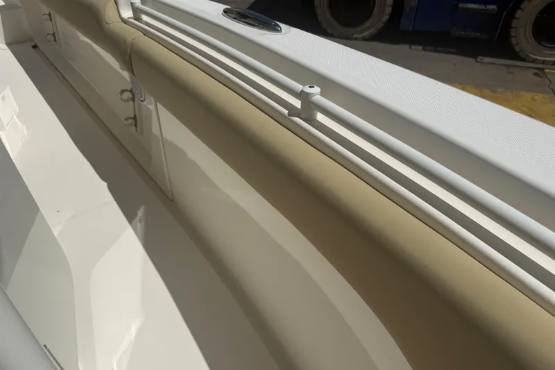 Slide: The Image of 2019 Key West Billistic 281 Center Console interior detail, featuring beige and white upholstery. - 121