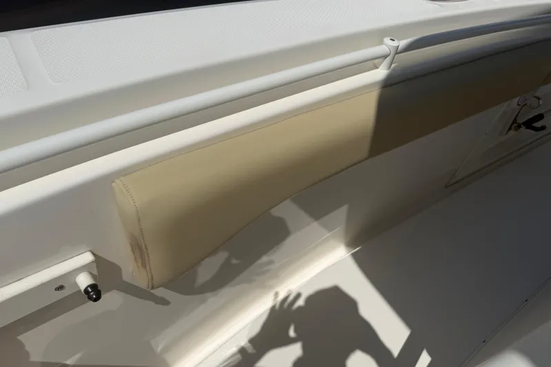 Slide: The Image of 2019 Key West Billistic 281 Center Console interior detail with beige cushioning. - 122