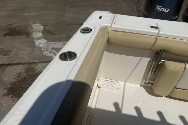 Slide: The Image of 2019 Key West Billistic 281 Center Console boat interior with beige seating and cup holders. - 123