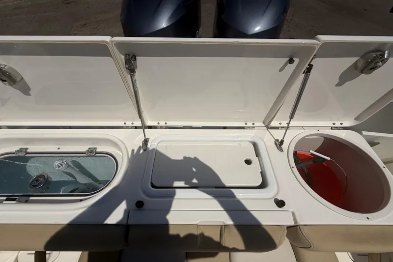 Slide: The Image of 2019 Key West Billistic 281 Center Console boat storage compartments open. - 36