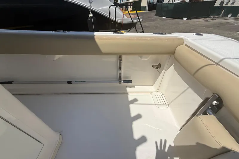 Slide: The Image of 2019 Key West Billistic 281 Center Console interior with beige seating and storage area. - 42
