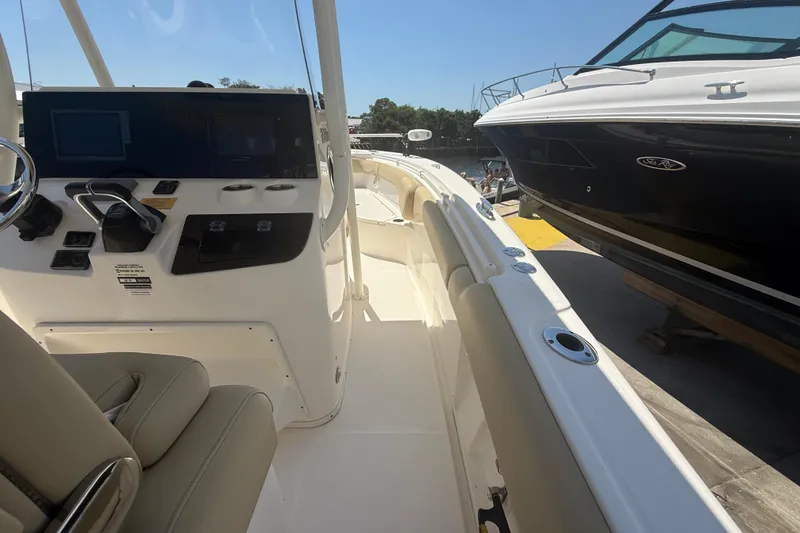 Slide: The Image of 2019 Key West Billistic 281 Center Console boat interior with control panel and seating. - 45