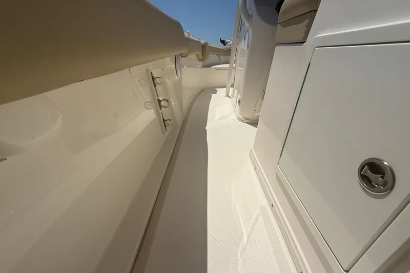 Slide: The Image of 2019 Key West Billistic 281 Center Console boat interior, featuring sleek white design and storage compartments. - 48
