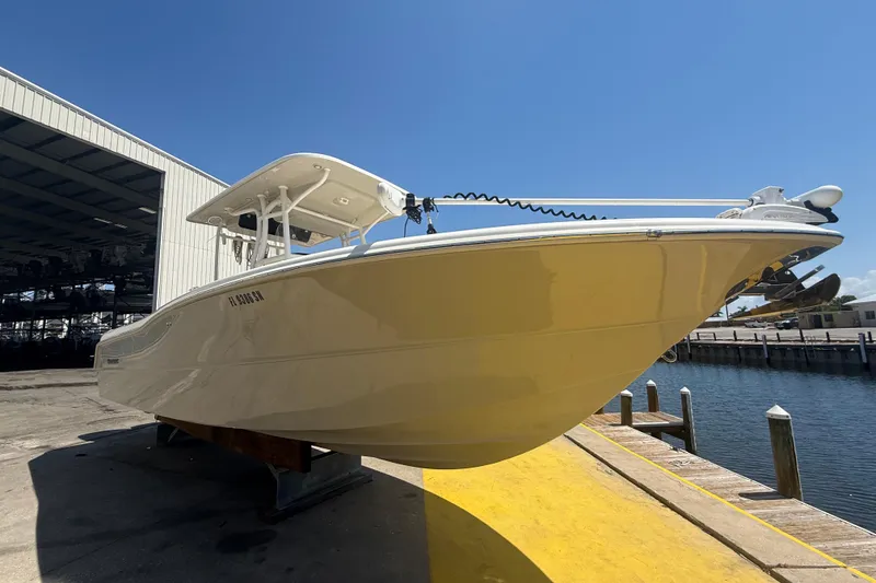 Slide: The Image of 2019 Key West Billistic 281 Center Console boat docked near a marina. - 5