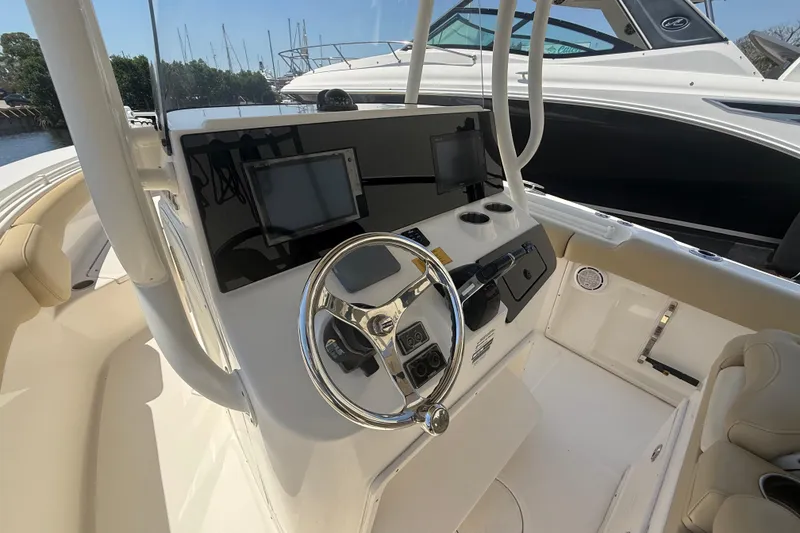 Slide: The Image of 2019 Key West Billistic 281 Center Console helm with dual displays and steering wheel. - 50