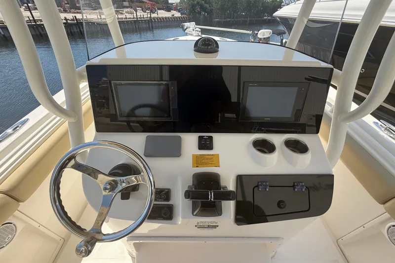Slide: The Image of 2019 Key West Billistic 281 Center Console helm with steering wheel and dual displays. - 51