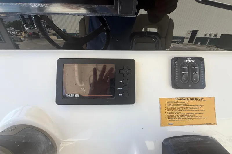 Slide: The Image of 2019 Key West Billistic 281 Center Console dashboard with Yamaha display and Lenco controls. - 54