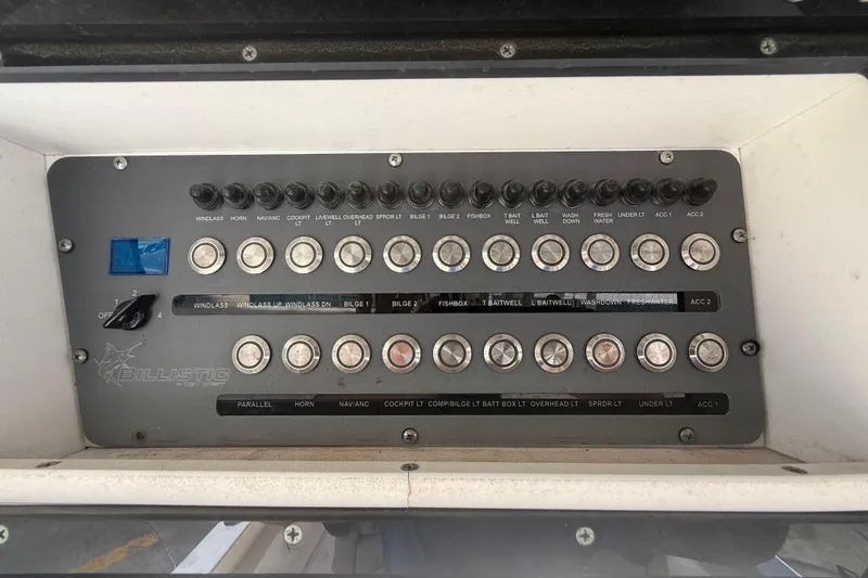Slide: The Image of Control panel of a 2019 Key West Billistic 281 Center Console boat with labeled switches. - 59