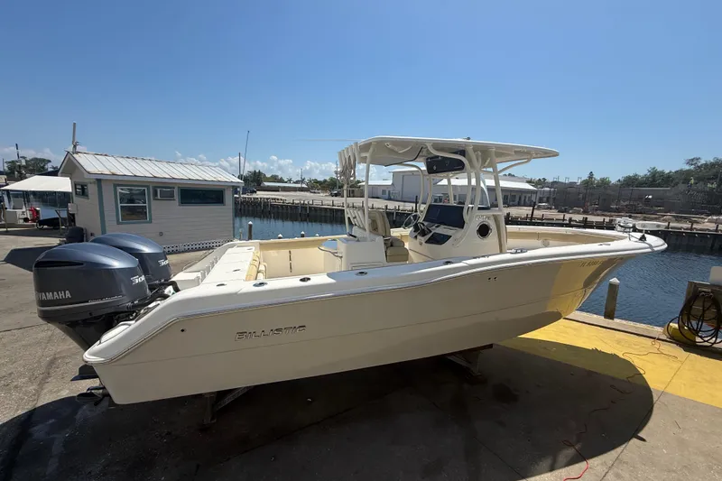 Slide: The Image of 2019 Key West Billistic 281 Center Console boat docked with twin Yamaha engines. - 6