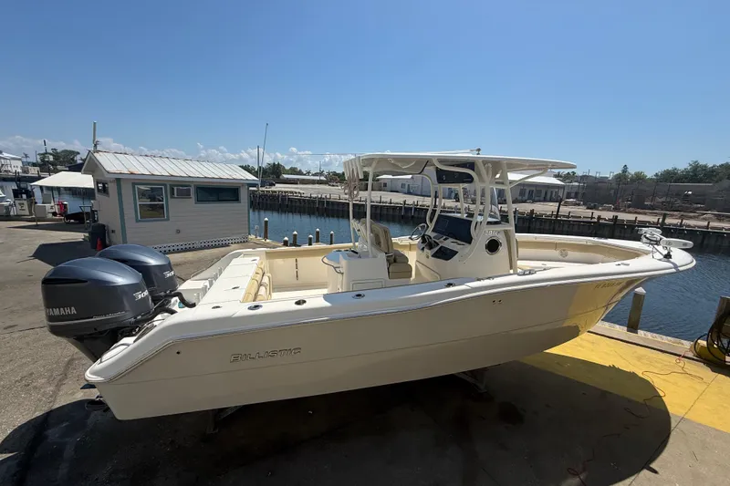 Slide: The Image of 2019 Key West Billistic 281 Center Console boat docked with twin Yamaha engines. - 7
