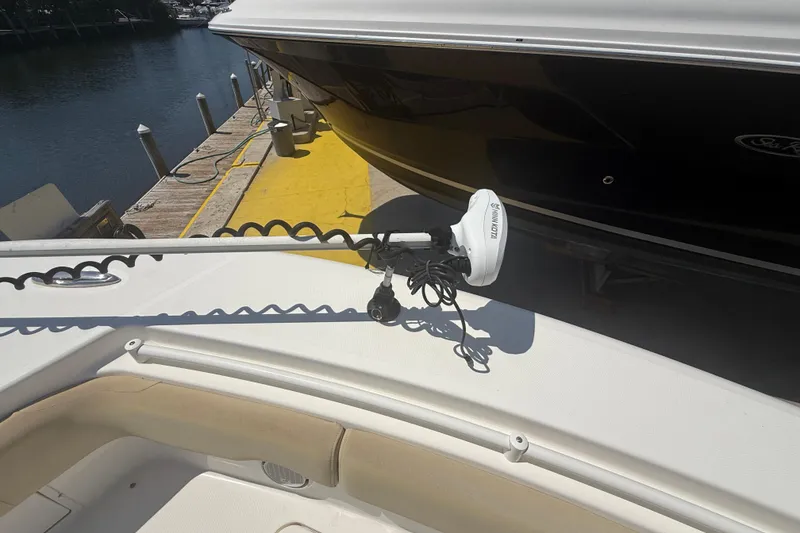 Slide: The Image of 2019 Key West Billistic 281 Center Console with Minn Kota trolling motor docked by water. - 82