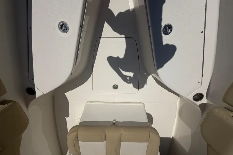Slide: The Image of 2019 Key West Billistic 281 Center Console interior with seating and storage compartments. - 86