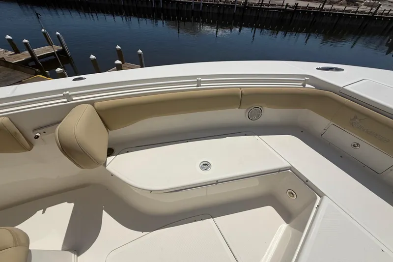 Slide: The Image of 2019 Key West Billistic 281 Center Console boat interior with beige seating and storage compartments. - 89