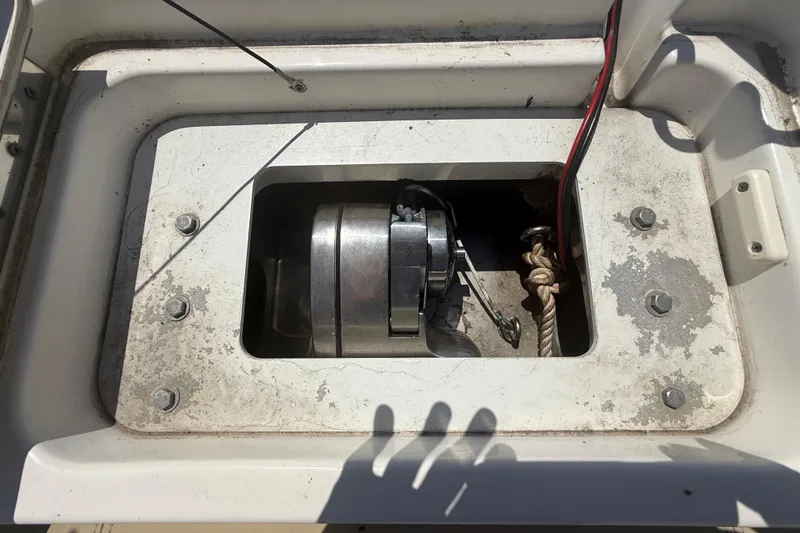 Slide: The Image of 2019 Key West Billistic 281 Center Console anchor compartment with winch and rope. - 95