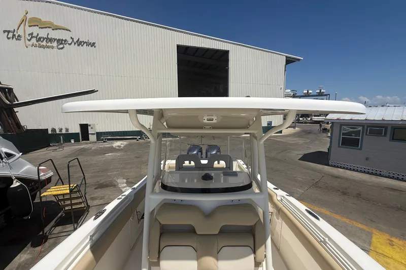 Slide: The Image of 2019 Key West Billistic 281 Center Console boat at marina, showcasing helm and seating area. - 96