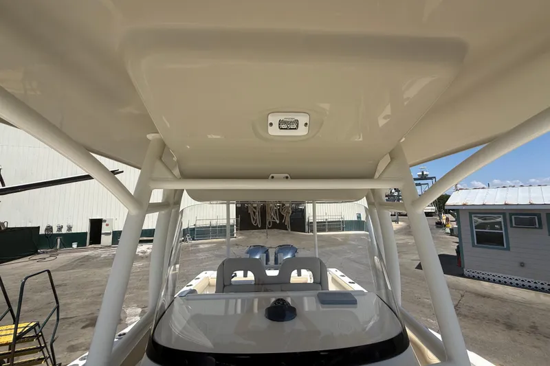 Slide: The Image of 2019 Key West Billistic 281 Center Console boat interior, showcasing helm and T-top structure. - 97