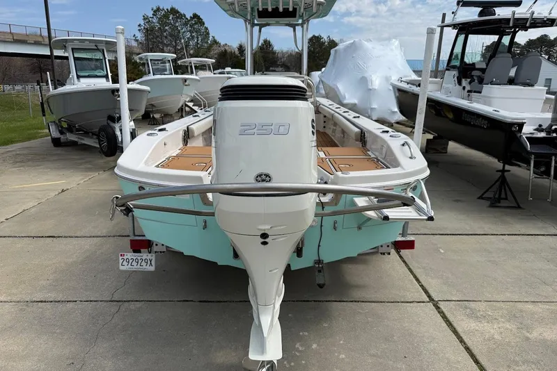 Slide: The Image of 2020 Carolina Skiff 26 Ultra Elite boat with powerful outboard motor, parked in marina. - 10