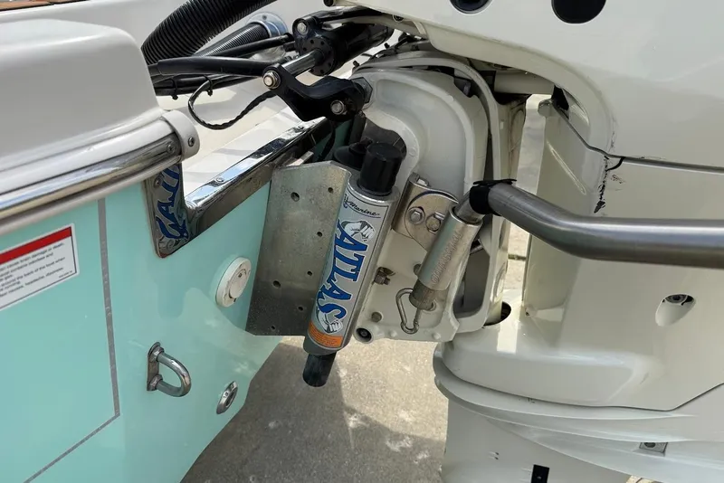 Slide: The Image of Close-up of 2020 Carolina Skiff 26 Ultra Elite boat motor and hydraulic system. - 11