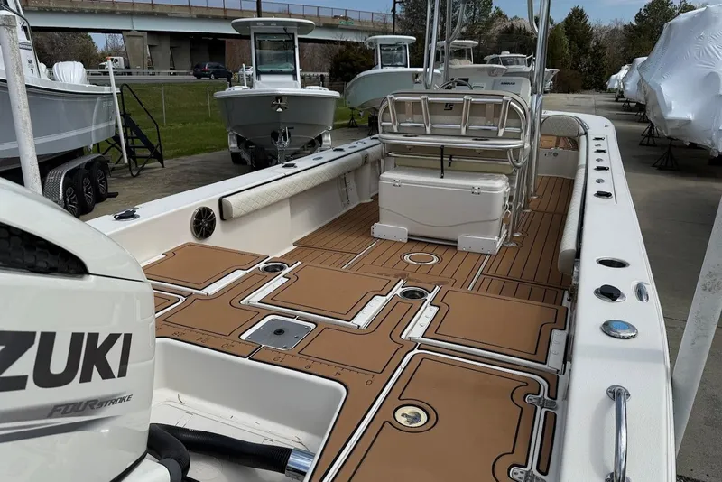 Slide: The Image of 2020 Carolina Skiff 26 Ultra Elite boat with Suzuki engine, featuring spacious deck and seating. - 12