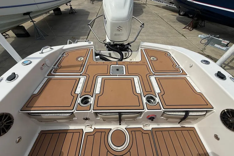Slide: The Image of 2020 Carolina Skiff 26 Ultra Elite boat deck with brown cushioned seating and Suzuki outboard motor. - 14