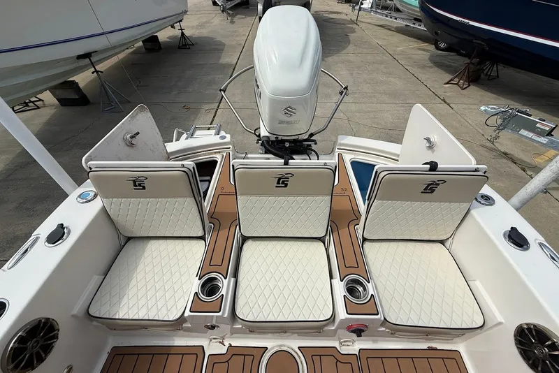 Slide: The Image of 2020 Carolina Skiff 26 Ultra Elite boat with cushioned seating and Suzuki outboard motor. - 15