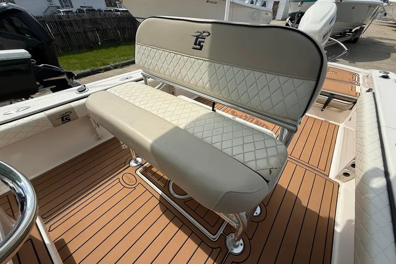 Slide: The Image of 2020 Carolina Skiff 26 Ultra Elite boat interior with cushioned seating and teak-style flooring. - 19