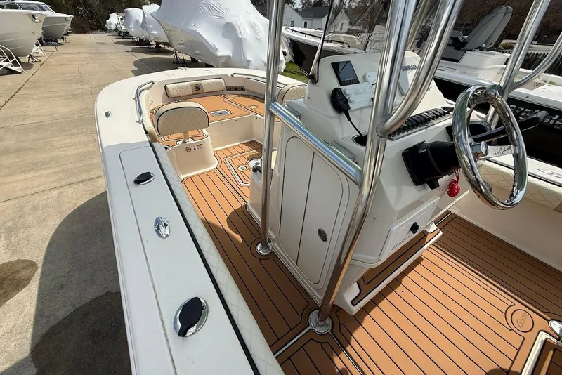 Slide: The Image of 2020 Carolina Skiff 26 Ultra Elite boat interior with sleek helm and wood-patterned flooring. - 23