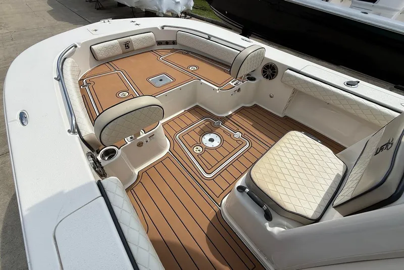 Slide: The Image of 2020 Carolina Skiff 26 Ultra Elite boat interior with cushioned seating and teak-style flooring. - 24