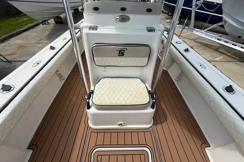 Slide: The Image of 2020 Carolina Skiff 26 Ultra Elite boat interior with cushioned seating and wood-patterned flooring. - 25