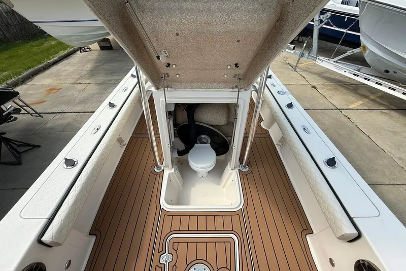 Slide: The Image of 2020 Carolina Skiff 26 Ultra Elite boat interior with open hatch and visible toilet. - 26