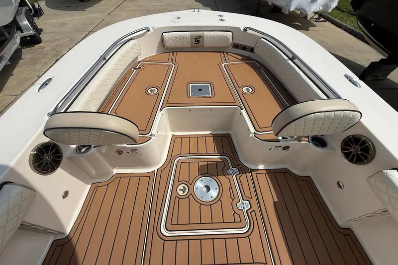 Slide: The Image of 2020 Carolina Skiff 26 Ultra Elite boat interior with cushioned seating and teak-style flooring. - 27