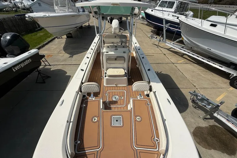 Slide: The Image of 2020 Carolina Skiff 26 Ultra Elite boat with spacious deck and seating, docked in a marina. - 29