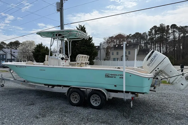 Slide: The Image of 2020 Carolina Skiff 26 Ultra Elite boat on trailer with Suzuki outboard motor. - 9