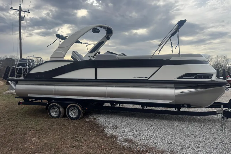 The Image of 2026 Harris Grand Mariner 250 SLDH pontoon boat on trailer, overcast sky. - 1