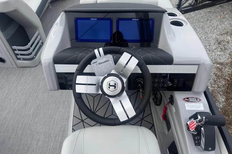 Slide: The Image of Steering console of 2026 Harris Grand Mariner 250 SLDH with dual Simrad displays. - 12