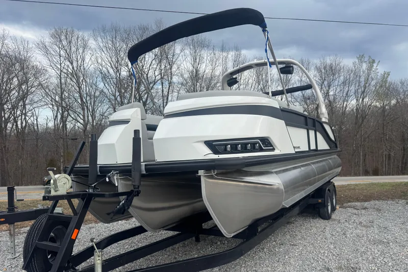 Slide: The Image of 2026 Harris Grand Mariner 250 SLDH pontoon boat on trailer, parked outdoors. - 4