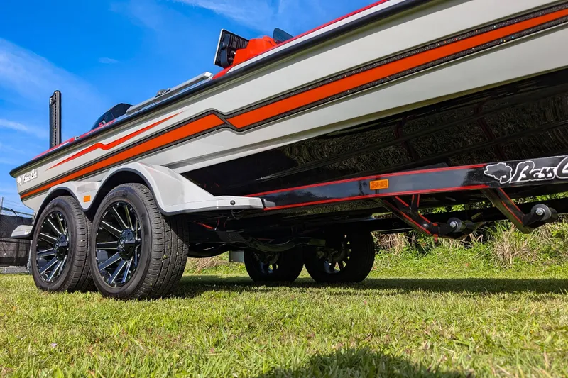 Slide: The Image of 2026 Bass Cat Lynx STS boat on trailer, showcasing sleek design and vibrant colors. - 14