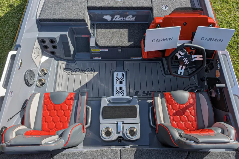 Slide: The Image of 2026 Bass Cat Lynx STS boat interior with red seats and dual Garmin displays. - 19