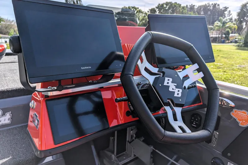 Slide: The Image of 2026 Bass Cat Lynx STS dashboard with Garmin displays and steering wheel. - 25