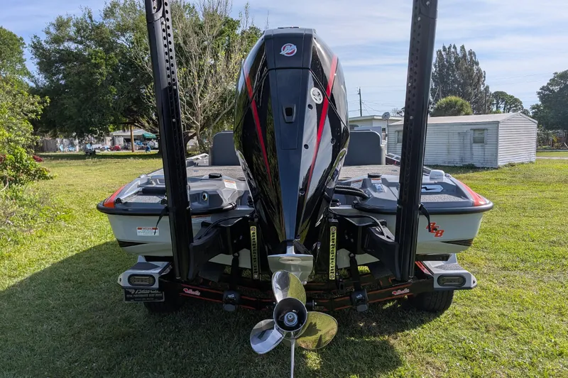 Slide: The Image of 2026 Bass Cat Lynx STS boat with powerful outboard motor on grassy area. - 28