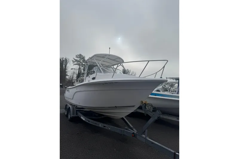Slide: The Image of 2007 Sea Fox 236 Walk Around boat on trailer under cloudy sky. - 1