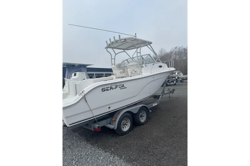 Slide: The Image of 2007 Sea Fox 236 Walk Around boat on trailer in outdoor setting. - 2