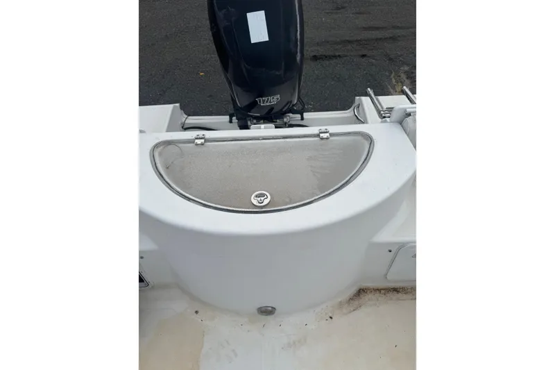 Slide: The Image of 2007 Sea Fox 236 Walk Around boat stern with outboard motor and storage compartment. - 5