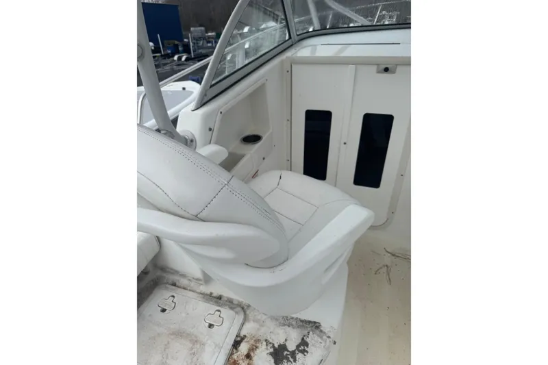 Slide: The Image of 2007 Sea Fox 236 Walk Around boat interior with white seating and cabin access. - 6